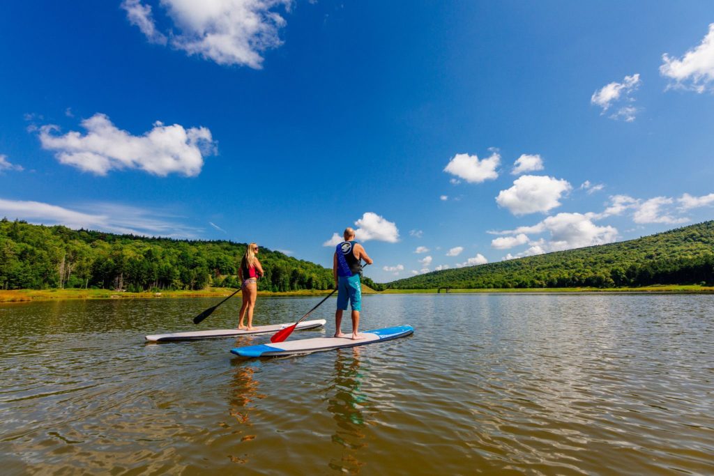 Couple Paddleboarding on Lake