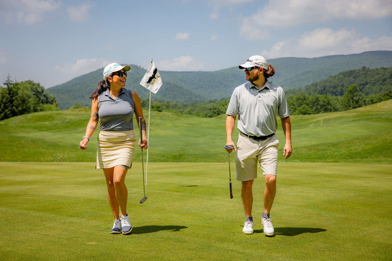 A couple playing The Raven Golf Club at Snowshoe Mountain