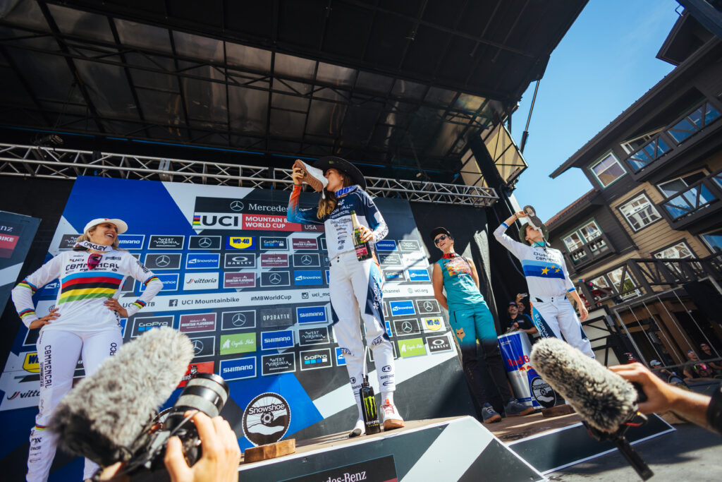 Camille Balanche takes a shoey on the podium